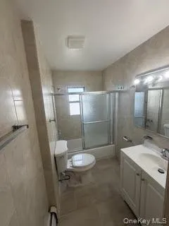 a bathroom with a sink a toilet a mirror and shower