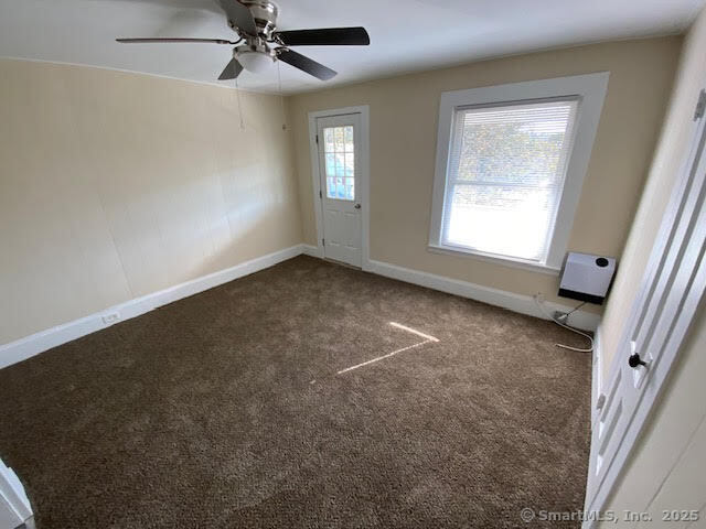 108 Washington Street Wallingford, CT 06492 - Photo 10 of 11 en empty room with windows and fan