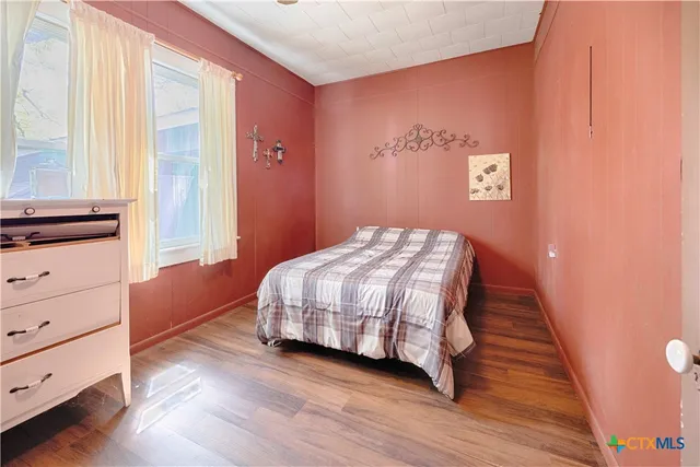 a bedroom with a bed and a dresser