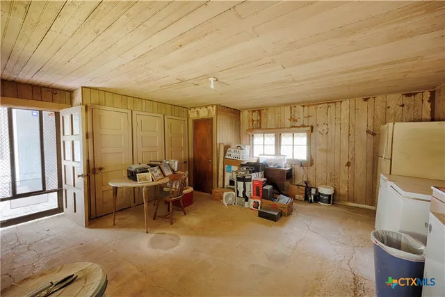 a living room with furniture a window and gym equipment