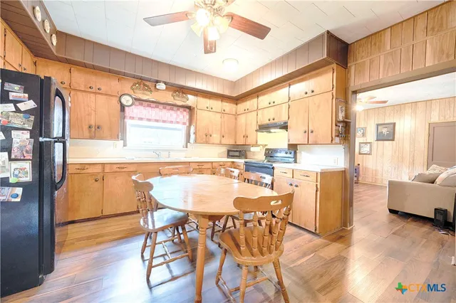 a view of a dining room with furniture a chandelier and wooden floor