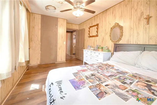 a bedroom with a large bed and a chandelier