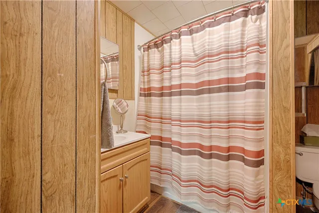 a bathroom with a shower curtain and a shower curtain