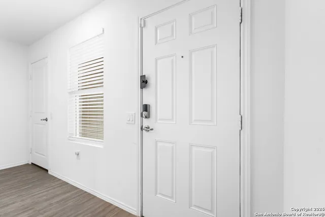 a view of a room with wooden floor and cabinet