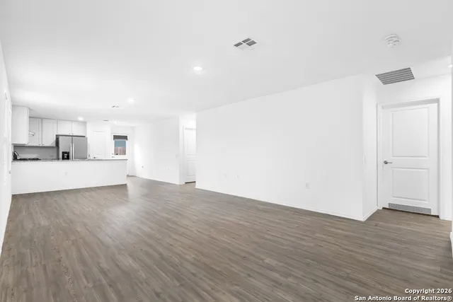 a view of a kitchen with wooden floor and a sink