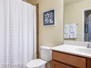 9723 Acqua Court, Unit 332 Naples, FL 34113 - Photo 11 of 23 a bathroom with a sink and a toilet