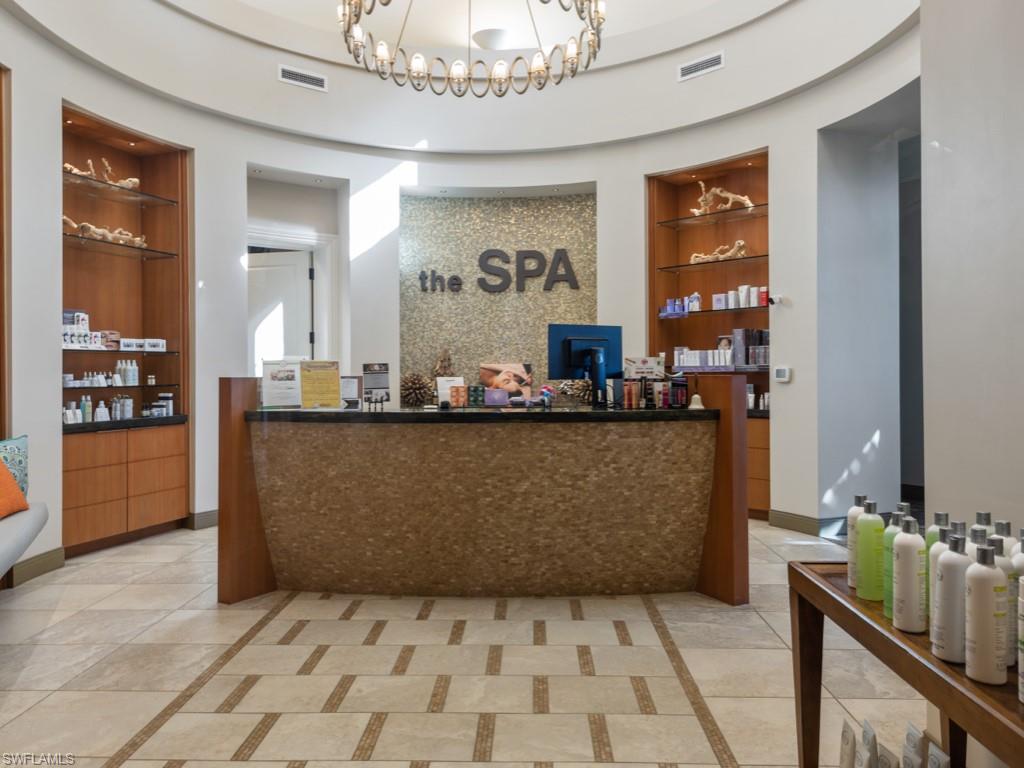 9723 Acqua Court, Unit 332 Naples, FL 34113 - Photo 22 of 23 a living room with a couch and a chandelier