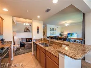 a kitchen with kitchen island granite countertop a sink table and chairs