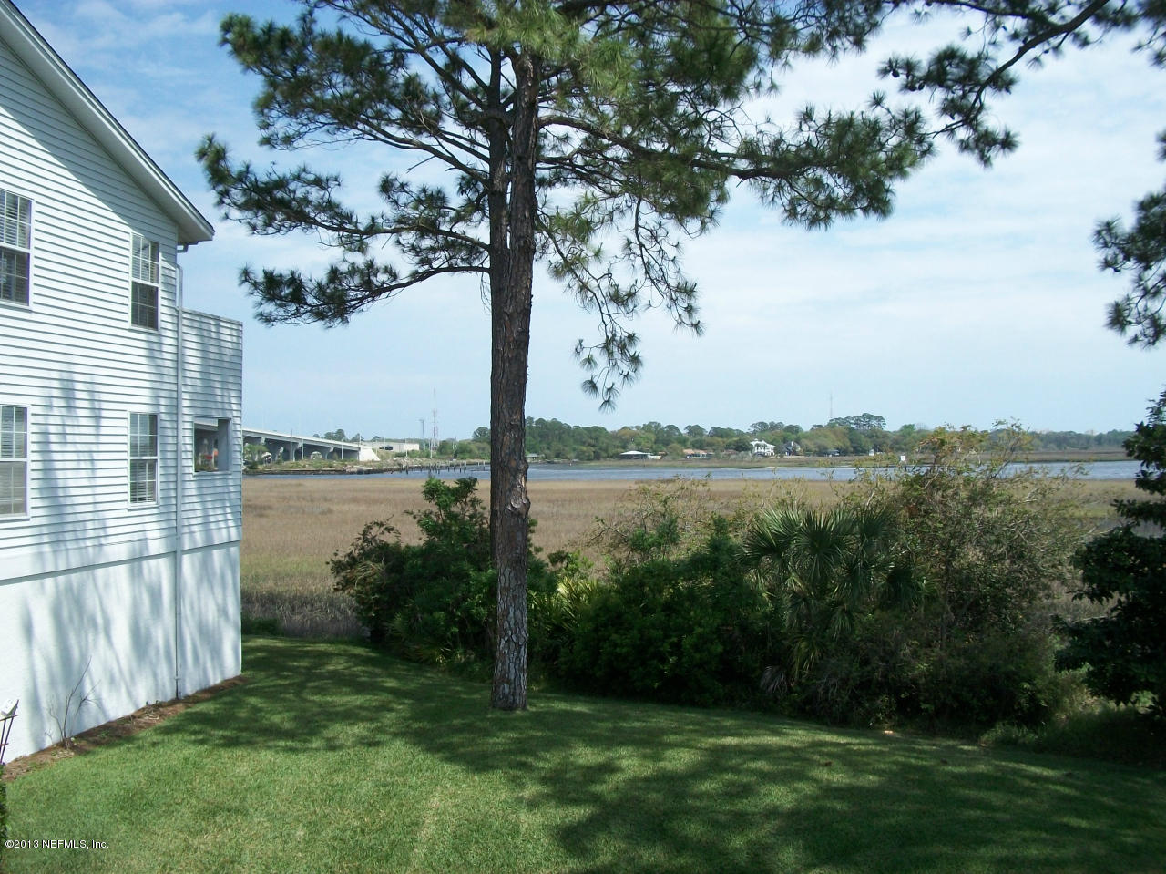 3387 Lighthouse Point Lane Jacksonville, FL 32250 - Photo 5 of 8 a view of a lake from a yard