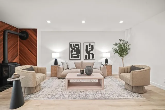 a living room with furniture and a potted plant