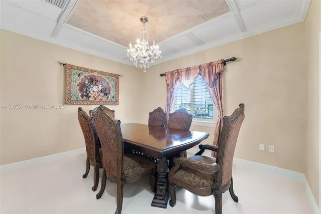 a view of a dining room with furniture and a chandelier