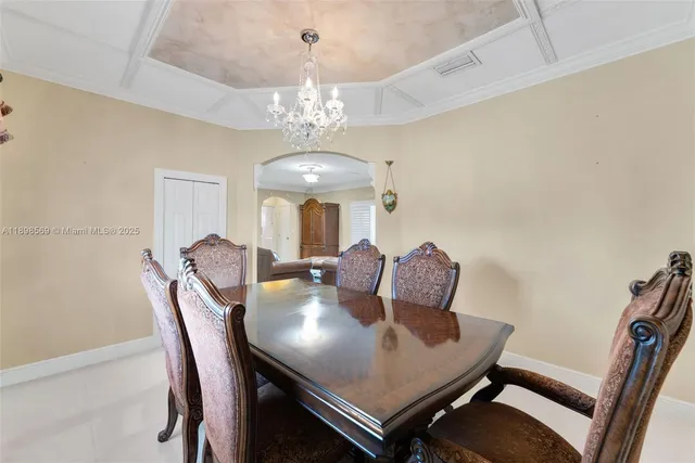 a view of a dining room with furniture and chandelier