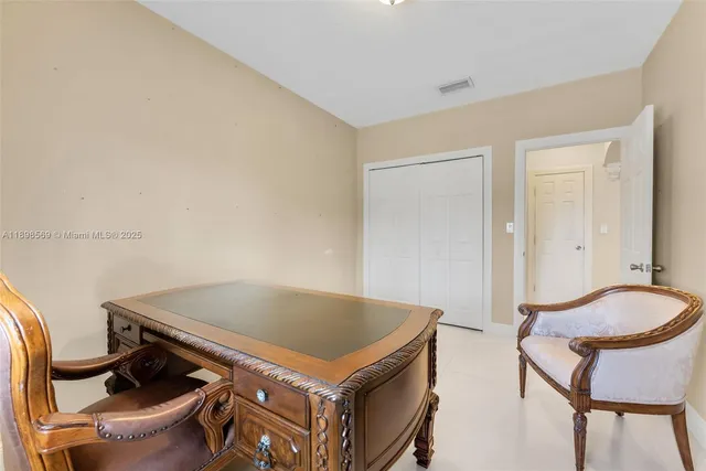 a living room with a table and chairs
