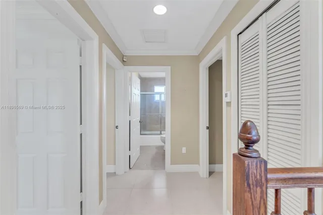 a view of a hallway to a livingroom and a window