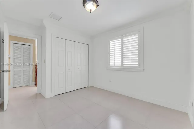a bedroom with bed and window