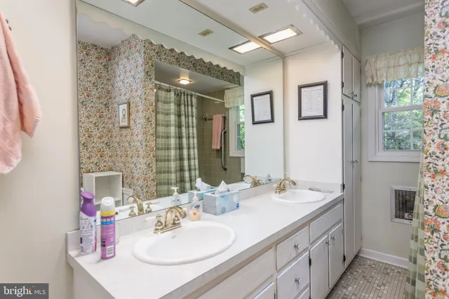 a bathroom with a double vanity sink mirror and double