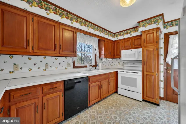 a kitchen with stainless steel appliances a refrigerator sink and cabinets