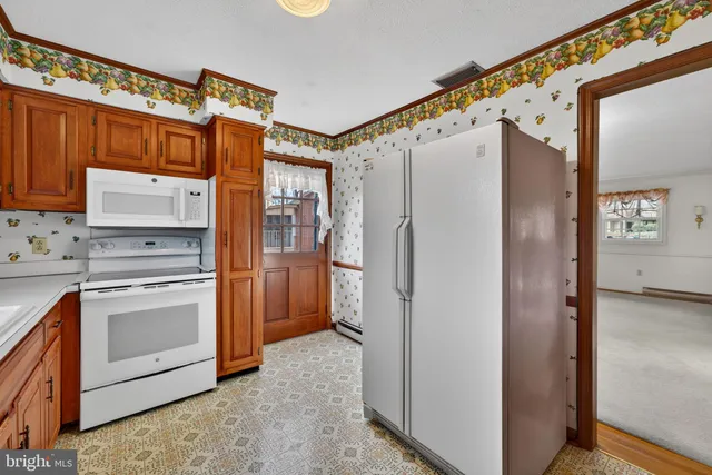 a kitchen with a sink cabinets and window