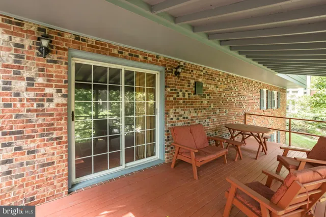 a view of a patio with table and chairs and wooden floor