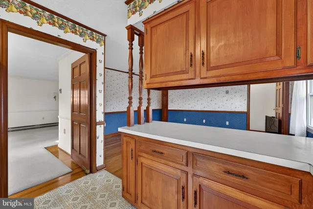 a kitchen with stainless steel appliances a sink cabinets and wooden floor