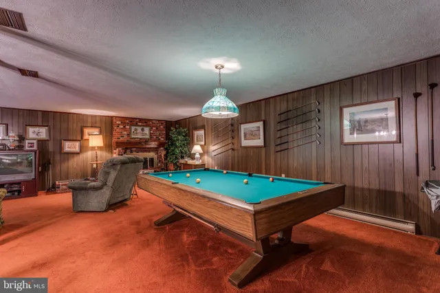 a room with pool table and windows