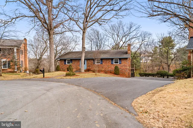 a view of a house with snow on the road