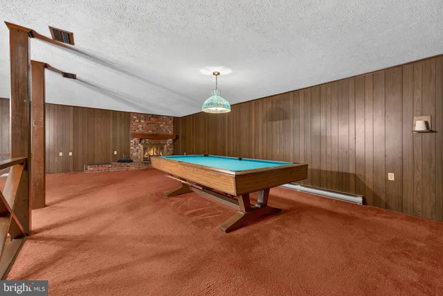 a room with pool tables and windows