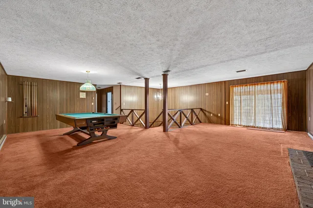 a room with pool table and window