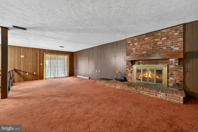 a bedroom with a bed and a dresser next to a window