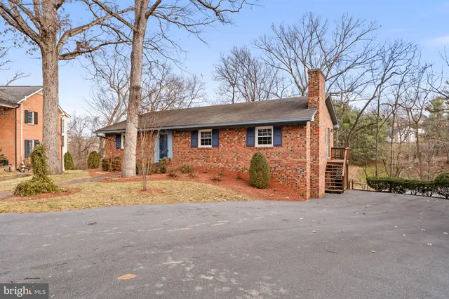 a view of a house with snow on the road