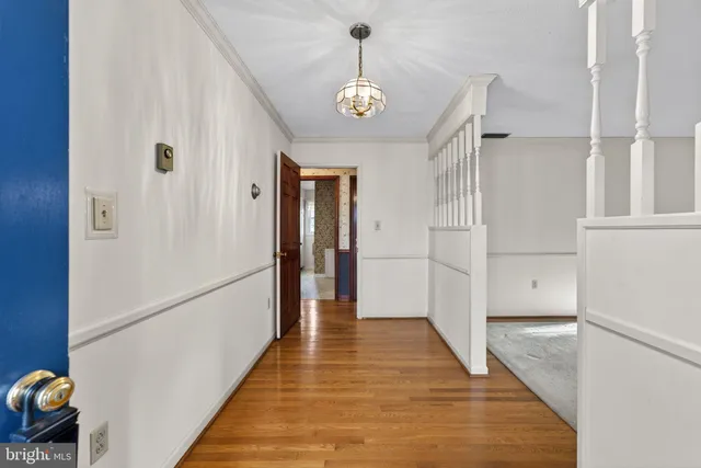 a view of a hallway view with wooden floor and staircase