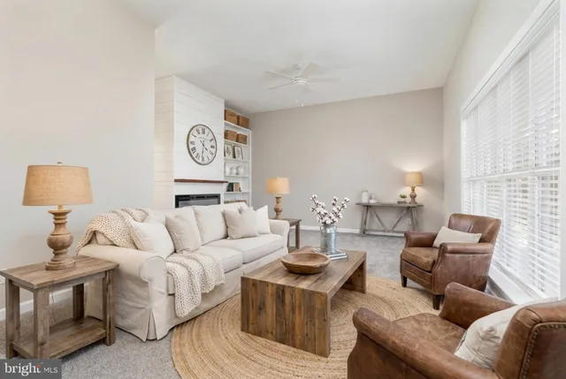 a living room with furniture and a lamp