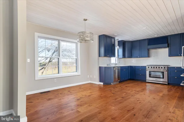 a large kitchen with cabinets a sink and a dishwasher