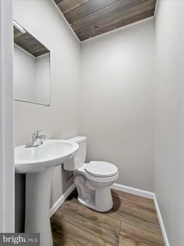 a white bath tub sitting in a bathroom next to a window