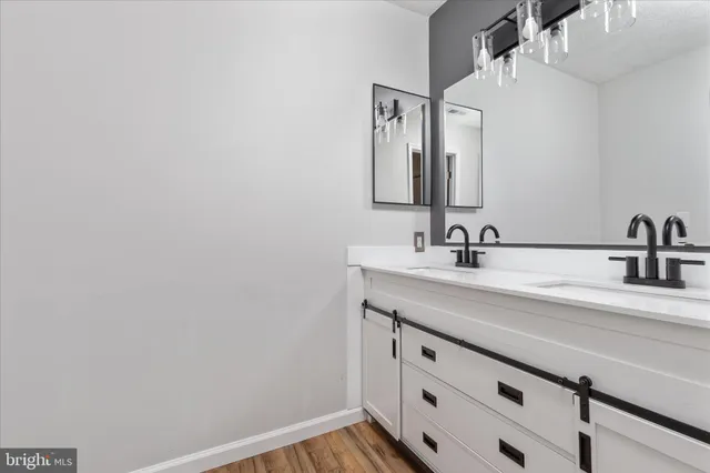 a bathroom with a shower a mirror and a sink