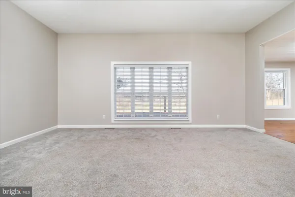 a view of a hallway with wooden floor and entryway