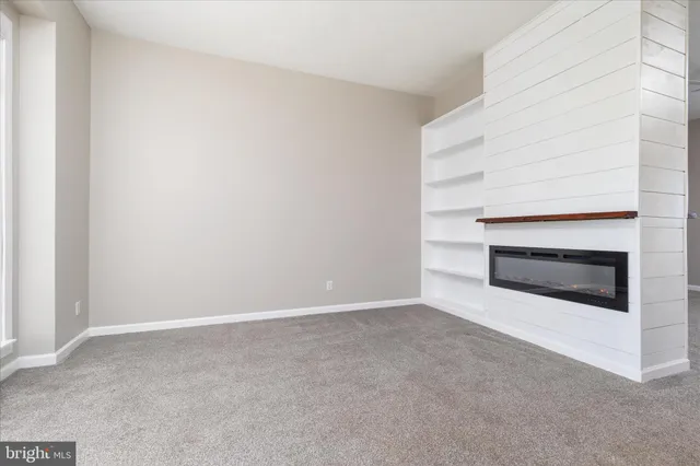 a view of an empty room with a fireplace