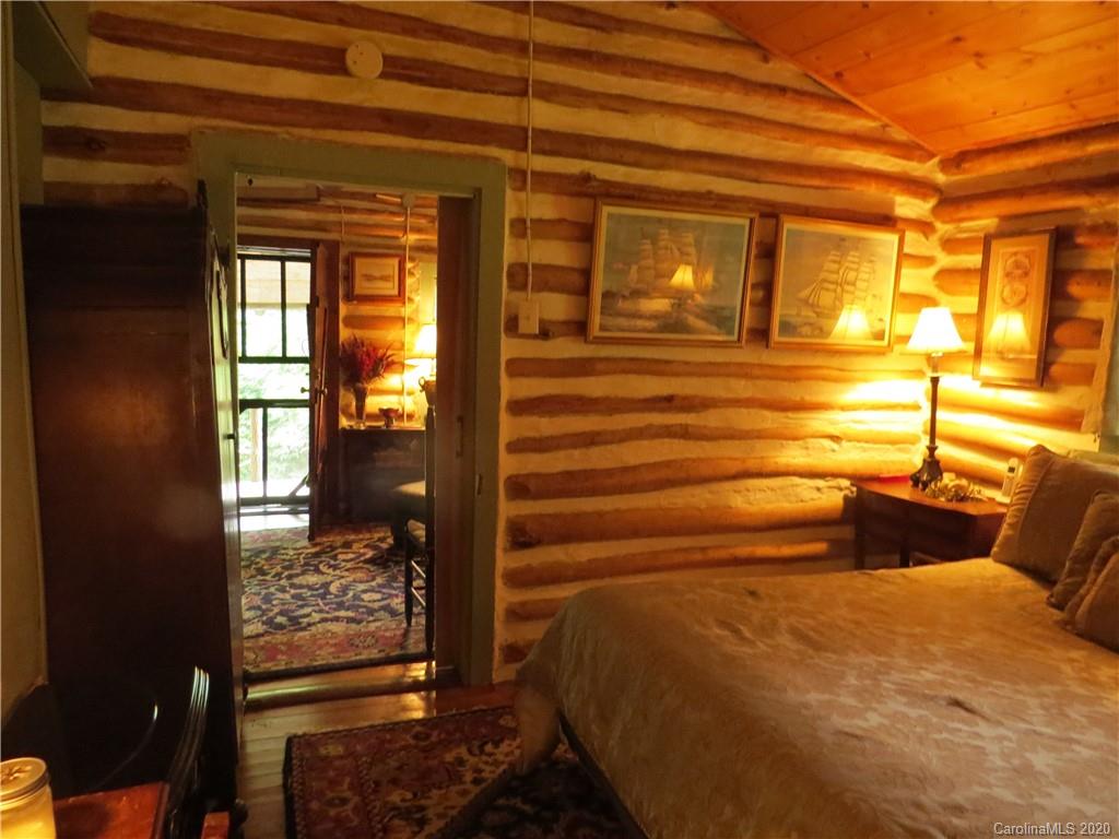 142 Cold Spring Road Burnsville, NC 28714 - Photo 20 of 34 a bedroom with a bed and wooden floor