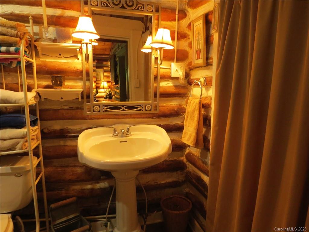 142 Cold Spring Road Burnsville, NC 28714 - Photo 22 of 34 a bathroom with a sink and a mirror