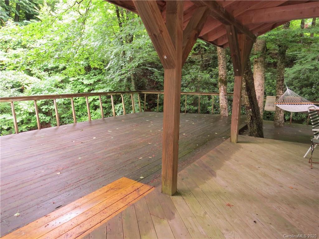 142 Cold Spring Road Burnsville, NC 28714 - Photo 26 of 34 a view of a backyard with large trees
