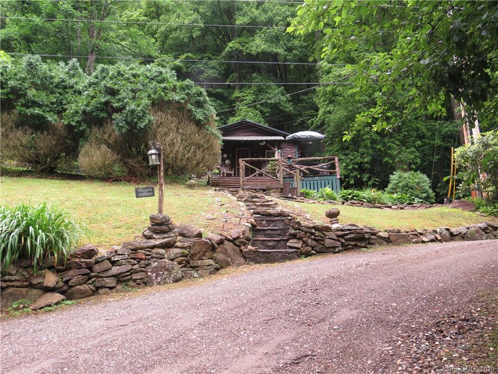 142 Cold Spring Road Burnsville, NC 28714 - Photo 34 of 34 a backyard of a house with lots of green space and fountain