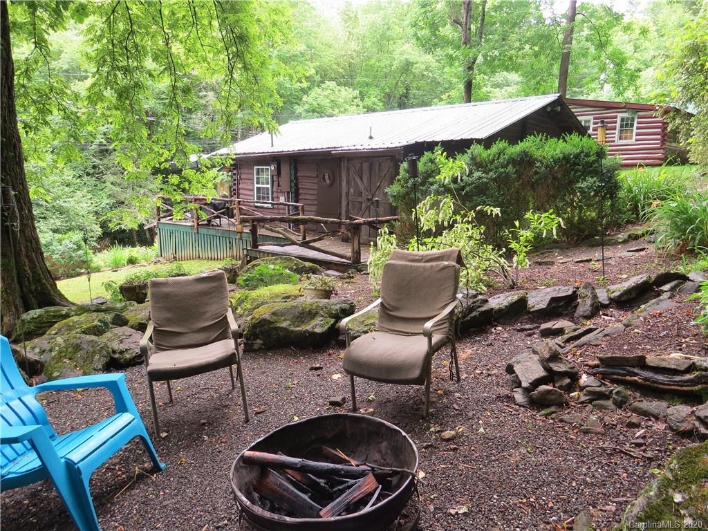 142 Cold Spring Road Burnsville, NC 28714 - Photo 7 of 34 a backyard of a house with yard fountain and outdoor seating