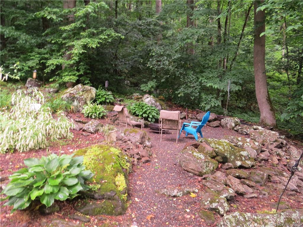 142 Cold Spring Road Burnsville, NC 28714 - Photo 8 of 34 a backyard of a house with a yard and outdoor seating