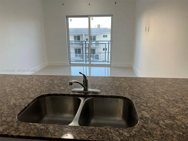 a kitchen with sink and window