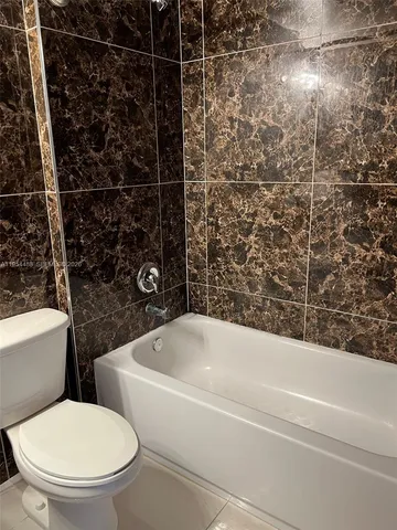 a bathroom with a toilet and a bathtub