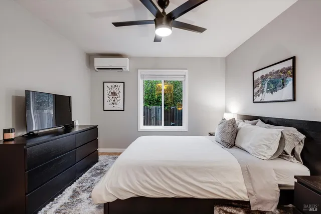 a bedroom with a bed and a flat screen tv