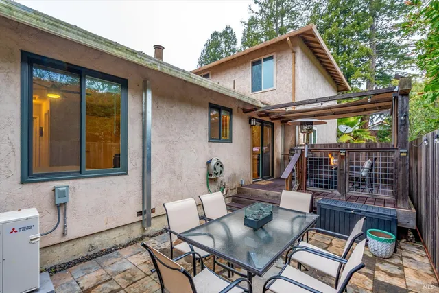 a view of house with backyard and outdoor seating