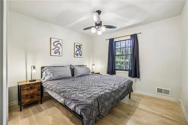 a bedroom with a large bed and a window