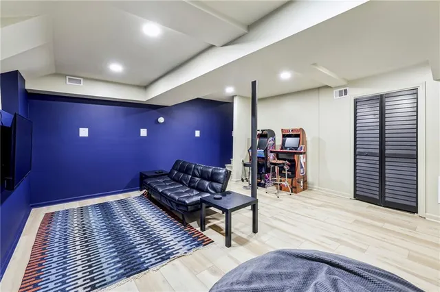 a living room with furniture and wooden floor