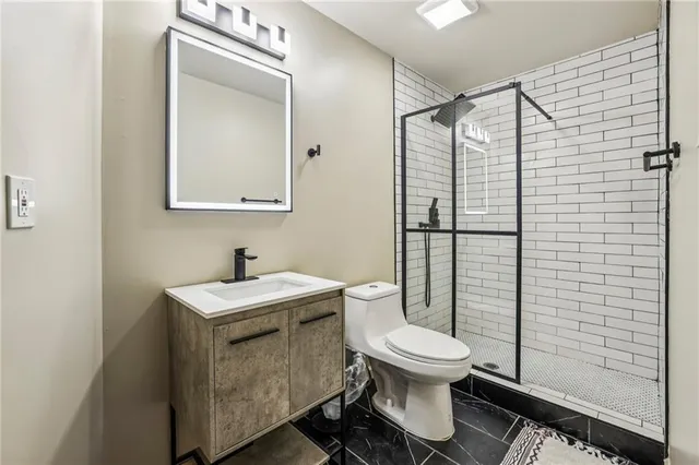 a bathroom with a toilet sink and shower